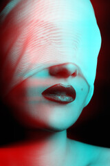 Woman portrait hiding her eyes under white ribbon or fabric in RGB color split effect style. RGB effect make reflection in red and blue colors. Abstract and futuristic looking style. Sensual mood
