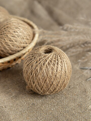 Tangles of jute twine threads in basket. Natural. Yarn for needlework. Vertical. Space for text