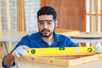 Indian professional bearded male engineer architect foreman labor worker carpenter using water...