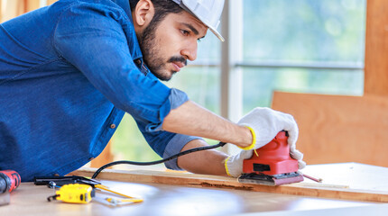 Indian professional bearded male engineer architect foreman labor worker carpenter wears safety...