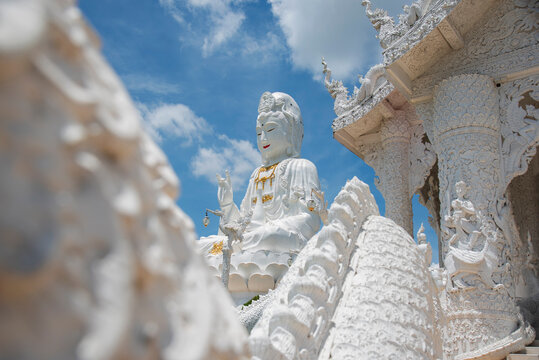 Beautiful Big White Guan Yin Statue and White Dragon at Wat Huay Pla Kang Buddhist Temple. Landmark of Chiang Rai. Located in Thailand.