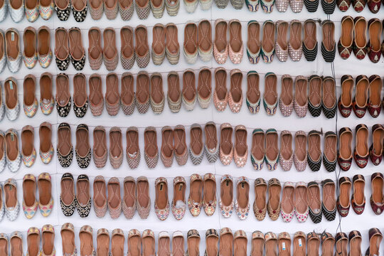 Colorful Handmade chappals (sandals) being sold in an Indian market, Handmade leather slippers, Traditional footwear.