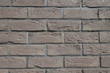 Rough surface of dark chocolate brown brick wall