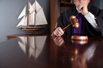 Judge in the office. Judge with the wooden gavel in his hand. Law and justice theme.