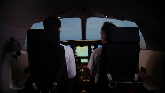 Two airplane pilots preparing for takeoff. Training in flight simulator.dashboard aircraft.