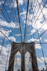 Symmetrical shot of the Brooklyn Bridge with beautiful clouds and blue sky