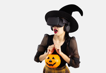 Halloween theme, young asian woman in witch costume wearing vr goggles for watching playing touching and feel scary on white background.