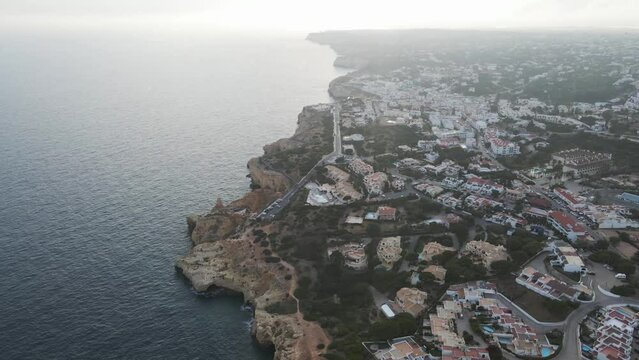 Aerial view of the coastline facing the Atlantic Ocean in Carvoeiro, Algarve region, Portugal.