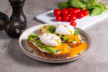 Two avocado open sandwiches with egg. Keto and diet concept. Healthy toast food for breakfast.
