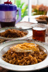 simple fried rice using leftover rice with fried egg and hot tea