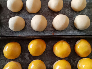 Nastar Cookies or Pineapple tarts are small, bite-size tart filled with pineapple jam. Nastar cookies in the baking tin. Nastar brushed with egg yolk.