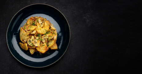 Fried potatoes with mushrooms and herbs on a plate