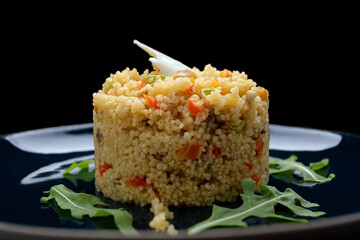 Couscous porridge with vegetables, butter and herbs