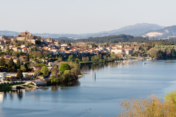 Fototapeta na wymiar Vista de la ciudad fronteriza de Tui, al noroeste de España. La fotografía es tomada desde Valença en Portugal, en la orilla opuesta del río Miño. Tui, Pontevedra, Galicia, España.
