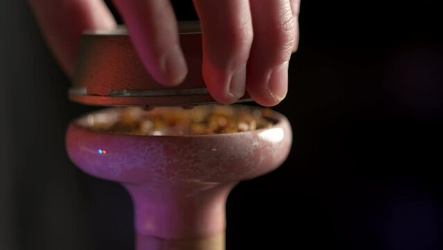 Hookah assembly. Putting bowl onto the tray.