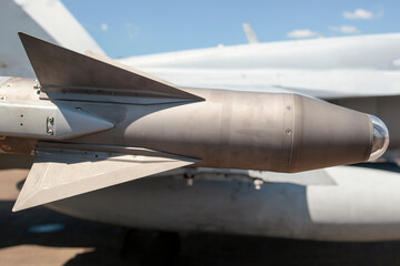 Fototapeta na wymiar A missile head on the wing of a fighter jet.