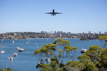 Plane flying over Sydney Harbour Sydney NSW Australia. 