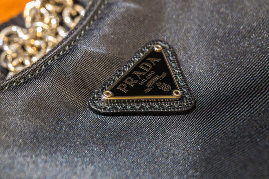 A close-up logo on a Prada women's bag from the New Collection. Focus with a shallow depth of field. 