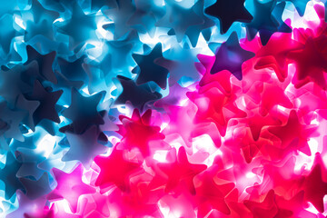 Pink and blue stars. Bright colored sequins, tinsel, confetti. Festive background for the gender party and the definition of a boy or a girl. Decor for new year, holiday, birthday. Close up. Top view.