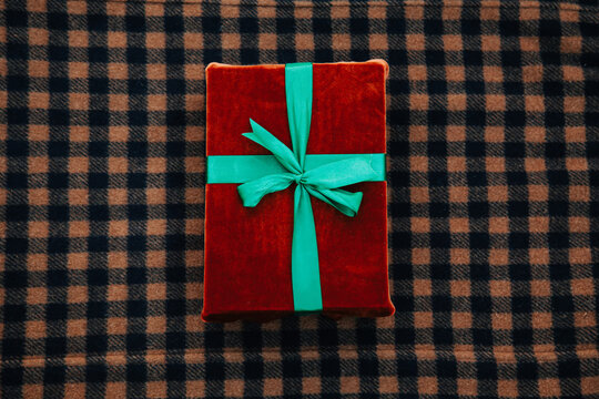 Eco Friendly Fabric Gift Box With Green Bow On Wool Clothes Background. Top View