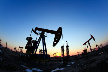 In the evening, oil pumps are running, Silhouette of beam pumping unit