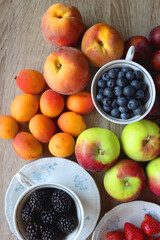 Various healthy seasonal food arranged on wooden background. Flat lay.