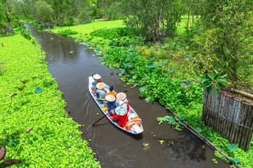 The ferryman takes traveler on a boat tour along the canals in the mangrove forest. This is an eco...