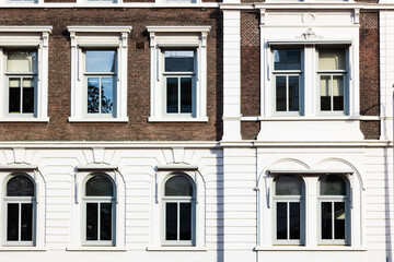 Fototapeta na wymiar Sunlight on the windows of an old office building
