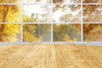 Desk of free space and autumn window background. 