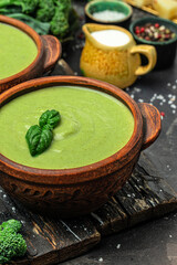 delicious broccoli soup with basil and cream, Diet detox food concept, vertical image. top view. place for text