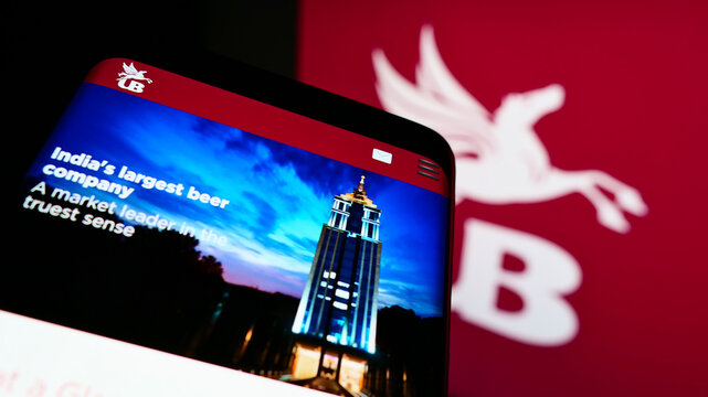 Stuttgart, Germany - 12-12-2021: Mobile phone with website of company United Breweries Holdings Limited (UBHL) on screen in front of logo. Focus on top-left of phone display.