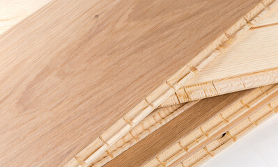 Oak engineered wood flooring boards in stack, fragment close-up