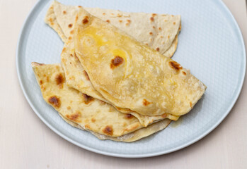 Pita cakes with butter on a plate. View from above.