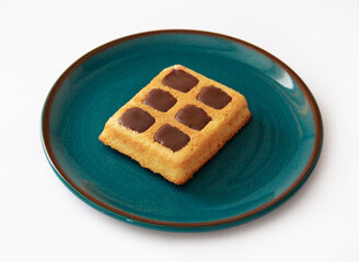sweet baked Belgian waffles with chocolate filling on a ceramic plate