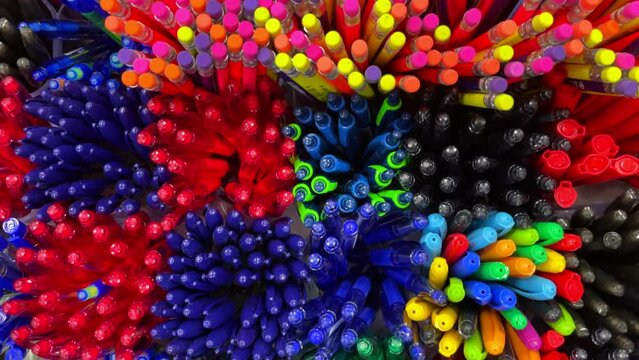 Colorful pencils and pens background texture. View from above. Selective focus