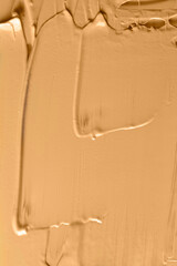Close up of cosmetic texture  Lliquid foundation  in beige color. Abstract skin tone background