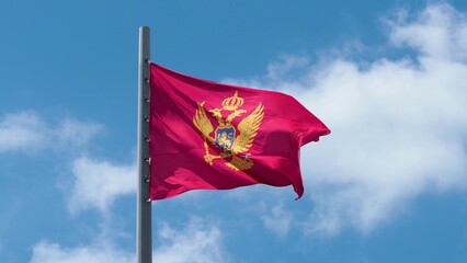 Montenegro, flag is fluttering in the wind photo on the background of the sky, outdoors. National flag