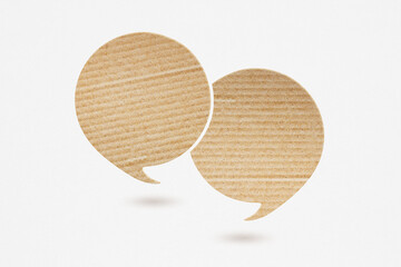 two blank speech bubble cardboard paper cut,  on grunge grey paper background. Conceptual image about communication and social media