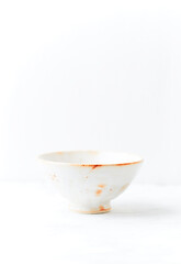Traditional ceramic bowl on bright background. Soft focus. Copy space.