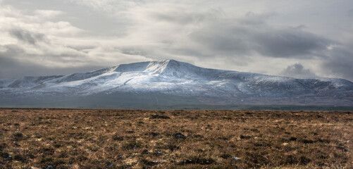 Winter in Ireland. A vast peatland landscape in North West Ireland. A wintry landscape with the snow-capped peaks of Wild Nephin National Park on the horizon.