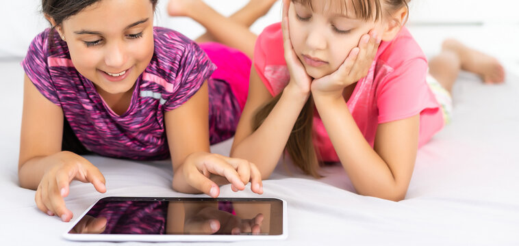 Little girls using tablet computer as art board - painting together