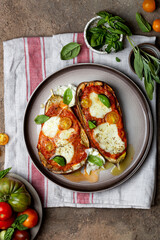 Baked eggplant with mozzarella cheese, tomatoes and basil