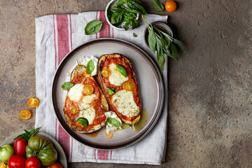 Baked eggplant with mozzarella cheese, tomatoes and basil