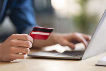 Online Shopping. Closeup shot of man using credit card and laptop