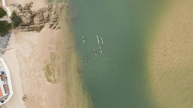 Aerial view of people doing kayak along Mira River in Vila Nova de Milfontes, Alentejo region, Portugal.
