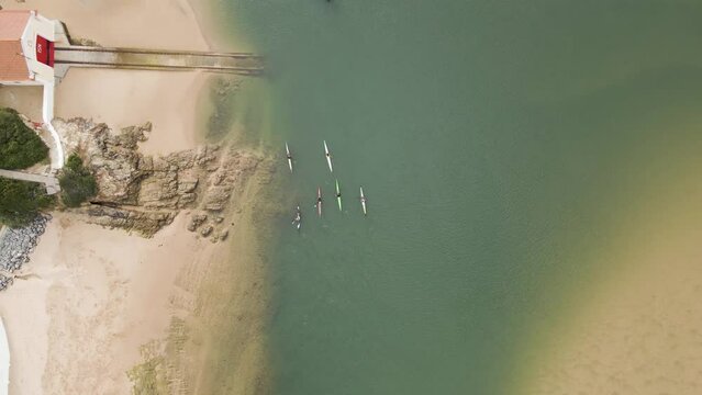 Aerial view of people doing kayak along Mira River in Vila Nova de Milfontes, Alentejo region, Portugal.