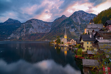 Fototapeta premium Amazing nightfall over Hallstatt. Scenic view of famous Hallstatt mountain village under picturesque moving clouds after sunset. UNESCO World Heritage, Hallstatt-Dachstein, Salzkammergut, Austria