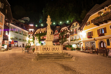 Night scenery of Market square in Hallstatt mountain village. Holy Trinity statue on foreground. UNESCO World Heritage, Hallstatt-Dachstein, Salzkammergut, Upper Austria