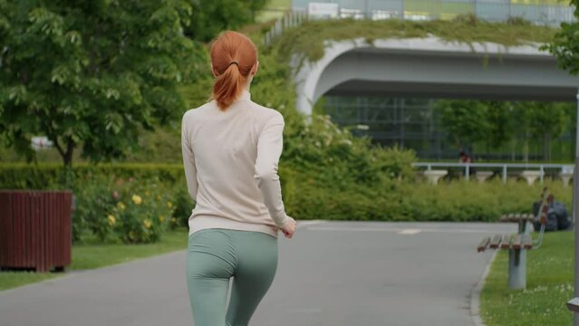 Anorexic person jogging in the park, skinny body. Eating disorder, malnutrition, unhealthy skinny body.