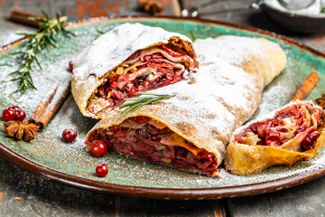Strudel with a cherry. . winter dessert strudel with cherry, cranberries and walnut. Food recipe...